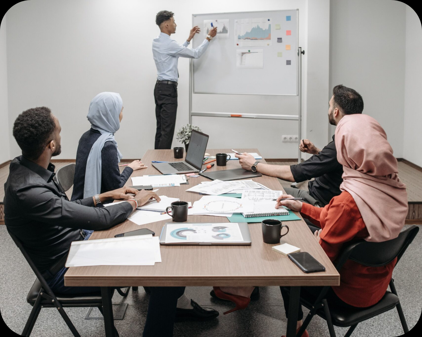Business meeting with diverse team discussing ideas in modern office.